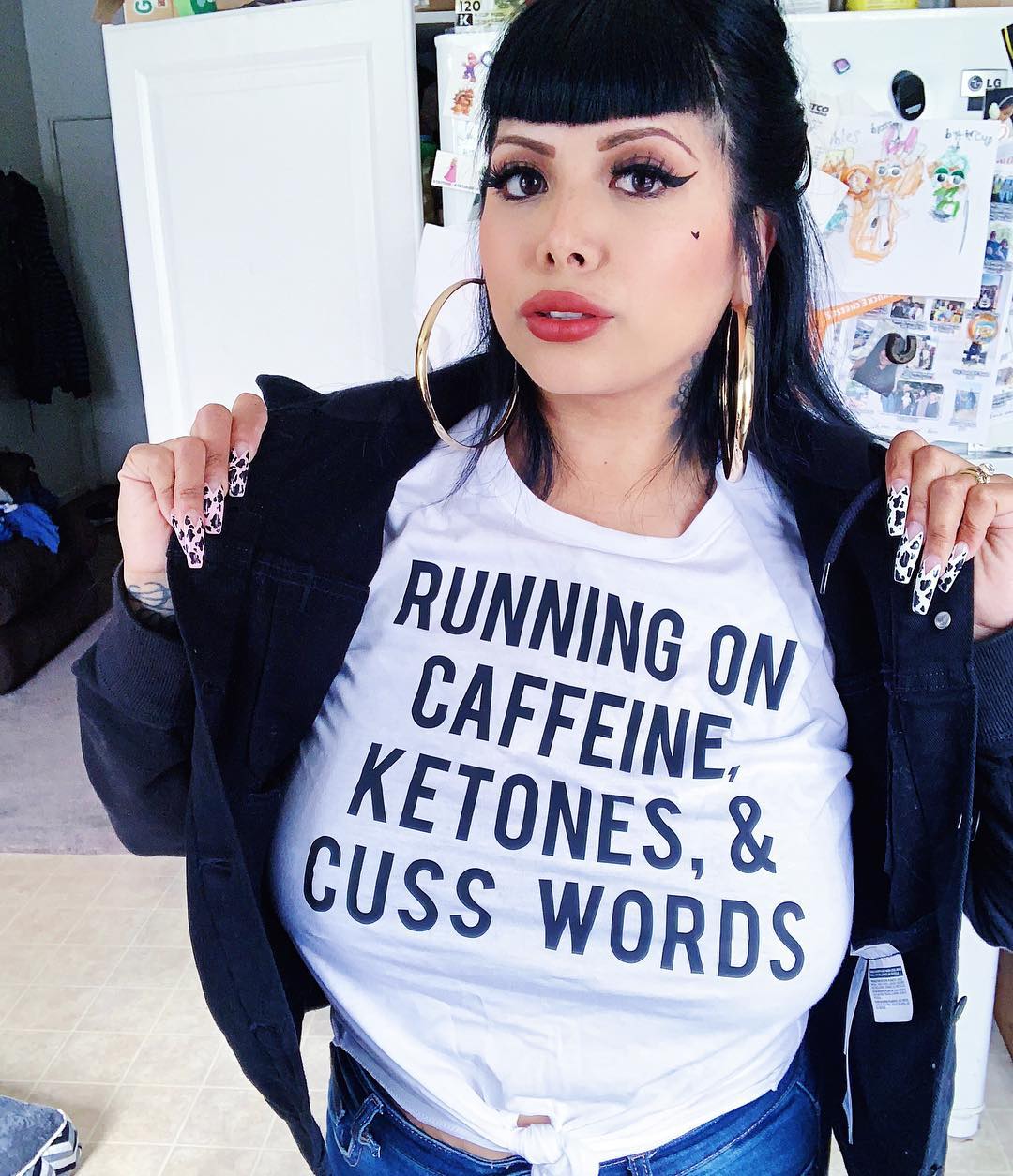 Black and white crop top with front tie featuring the slogan 'RUNNING ON CAFFEINE KETONES & CUSS WORDS'.