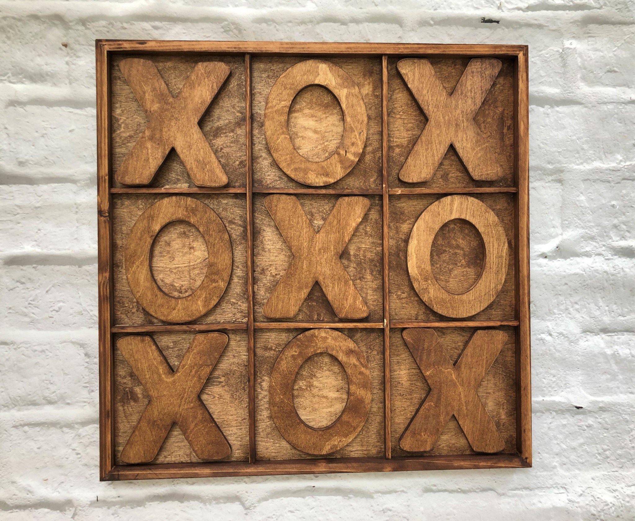 Rustic Handmade Warm Chestnut Giant Tic Tac Toe game set with hand cut Xs and Os on a wooden board.