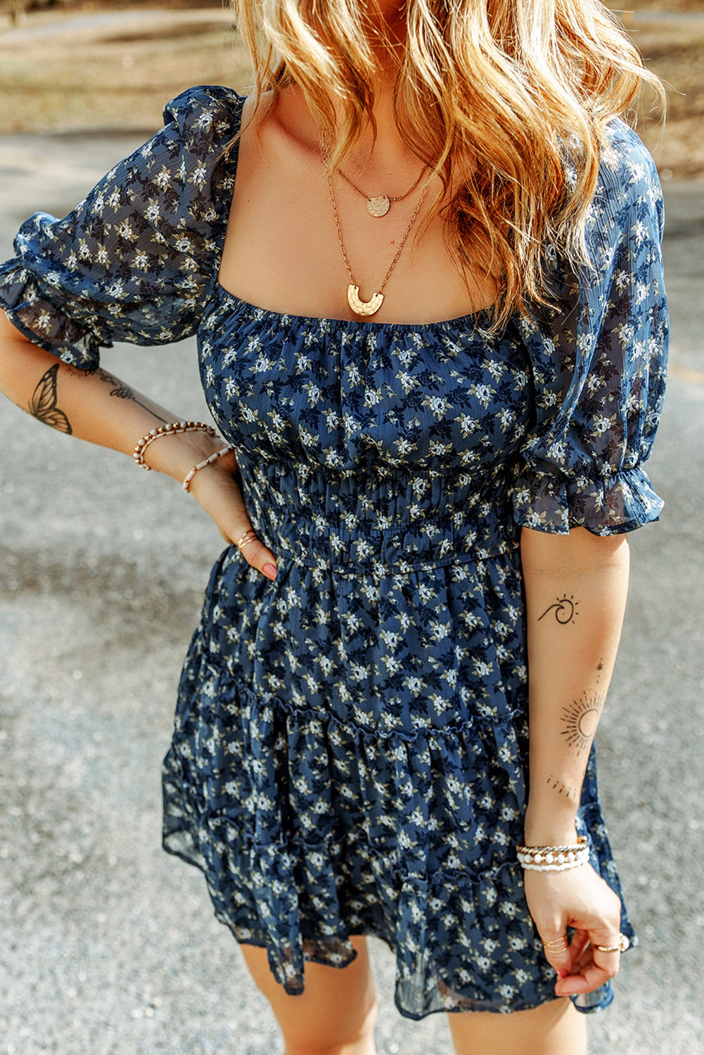 A stylish Sail Blue Floral Smocked Tiered Ruffle Short Dress featuring a floral print, smocked bodice, and tiered ruffle details, perfect for summer occasions.