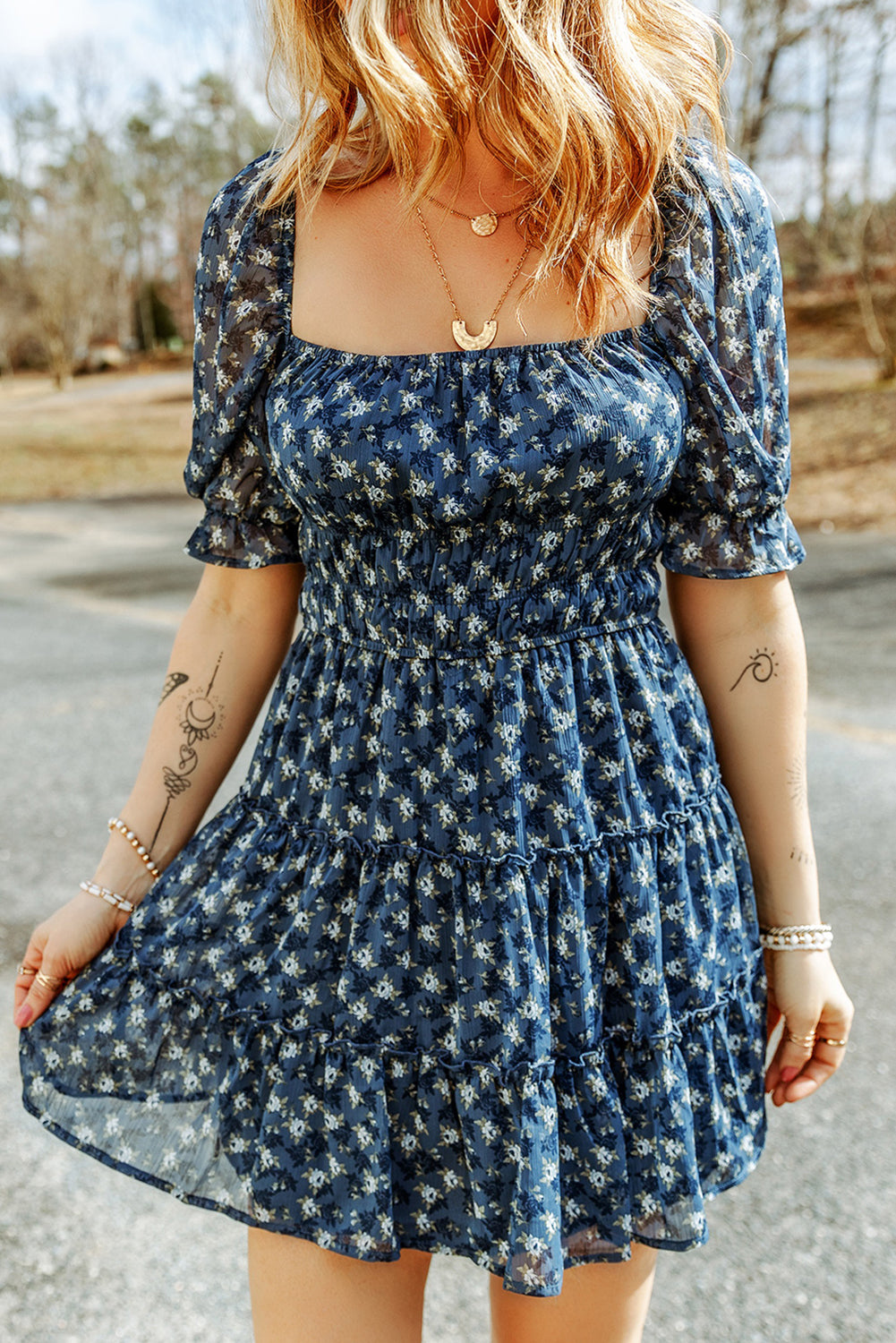 A stylish Sail Blue Floral Smocked Tiered Ruffle Short Dress featuring a floral print, smocked bodice, and tiered ruffle details, perfect for summer occasions.