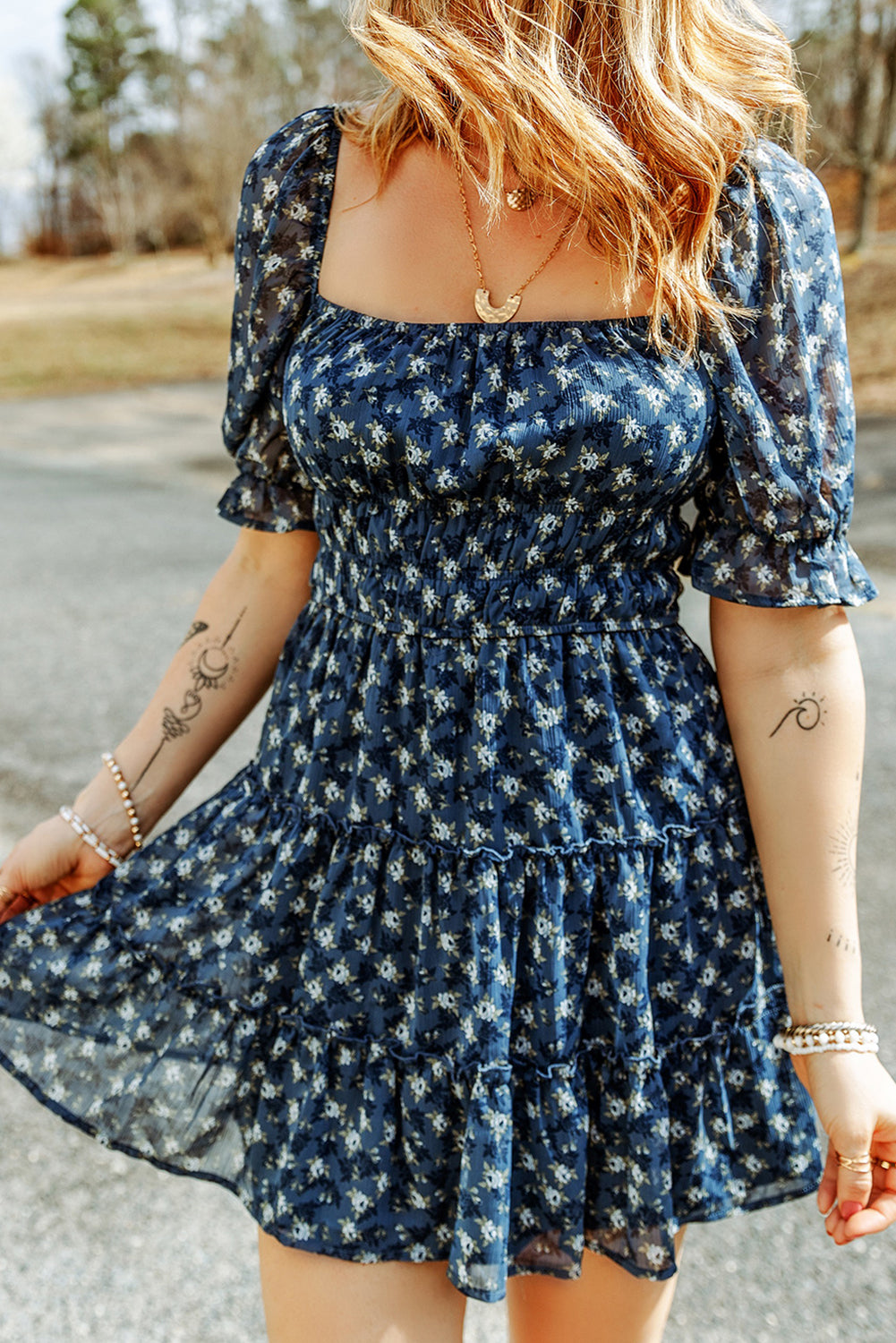 A stylish Sail Blue Floral Smocked Tiered Ruffle Short Dress featuring a floral print, smocked bodice, and tiered ruffle details, perfect for summer occasions.