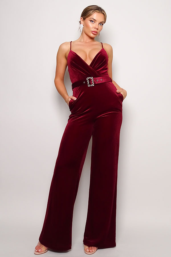 Samba Rhinestone Belt Velvet Jumpsuit in burgundy with spaghetti straps and rhinestone buckle belt, showcasing a deep V neckline and gathered bust detail.