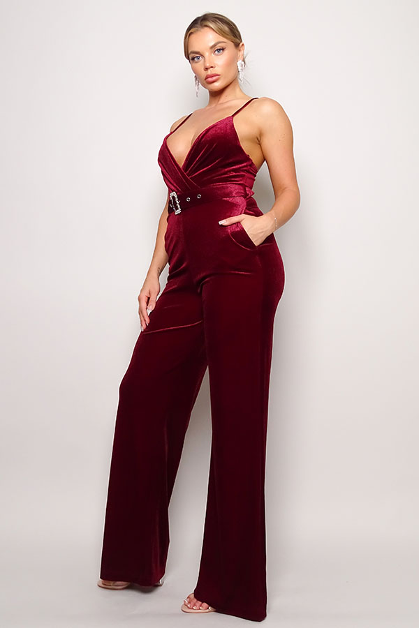 Samba Rhinestone Belt Velvet Jumpsuit in burgundy with spaghetti straps and rhinestone buckle belt, showcasing a deep V neckline and gathered bust detail.