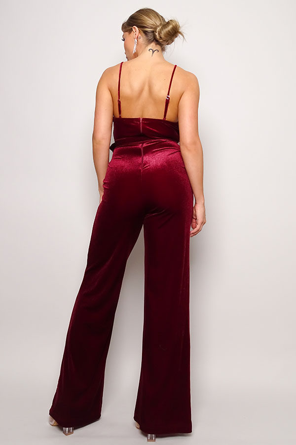 Samba Rhinestone Belt Velvet Jumpsuit in burgundy with spaghetti straps and rhinestone buckle belt, showcasing a deep V neckline and gathered bust detail.