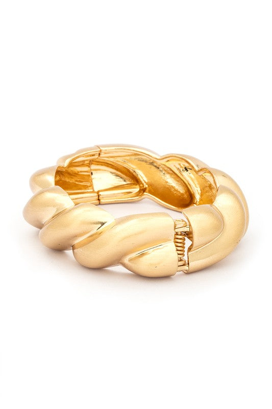 A polished hinged bangle featuring a scallop texture, elegantly designed in 18 KT gold plating.