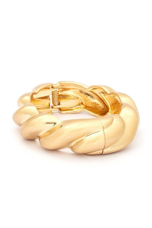 A polished hinged bangle featuring a scallop texture, elegantly designed in 18 KT gold plating.