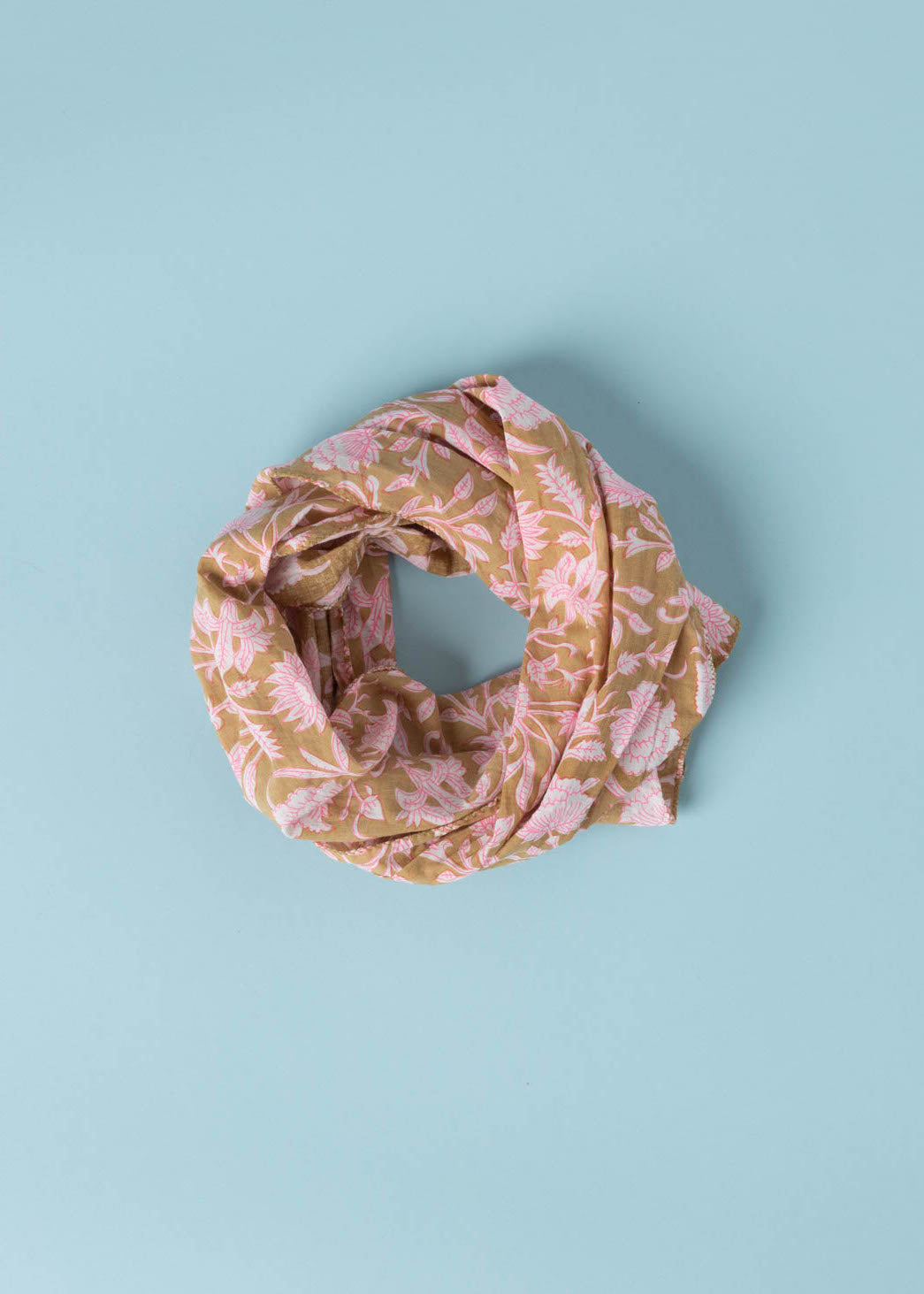 Floral Escape Skinny Scarf in Baked Clay and Neon Pink, showcasing vibrant floral patterns and organic cotton texture.