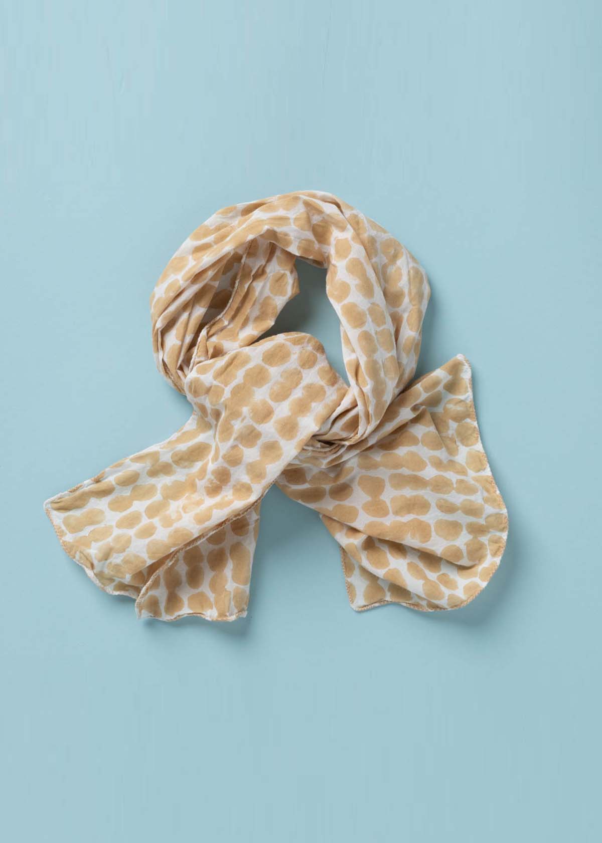 Messy Dot Skinny Scarf made from organic cotton, featuring a colorful block print design, perfect for versatile styling.