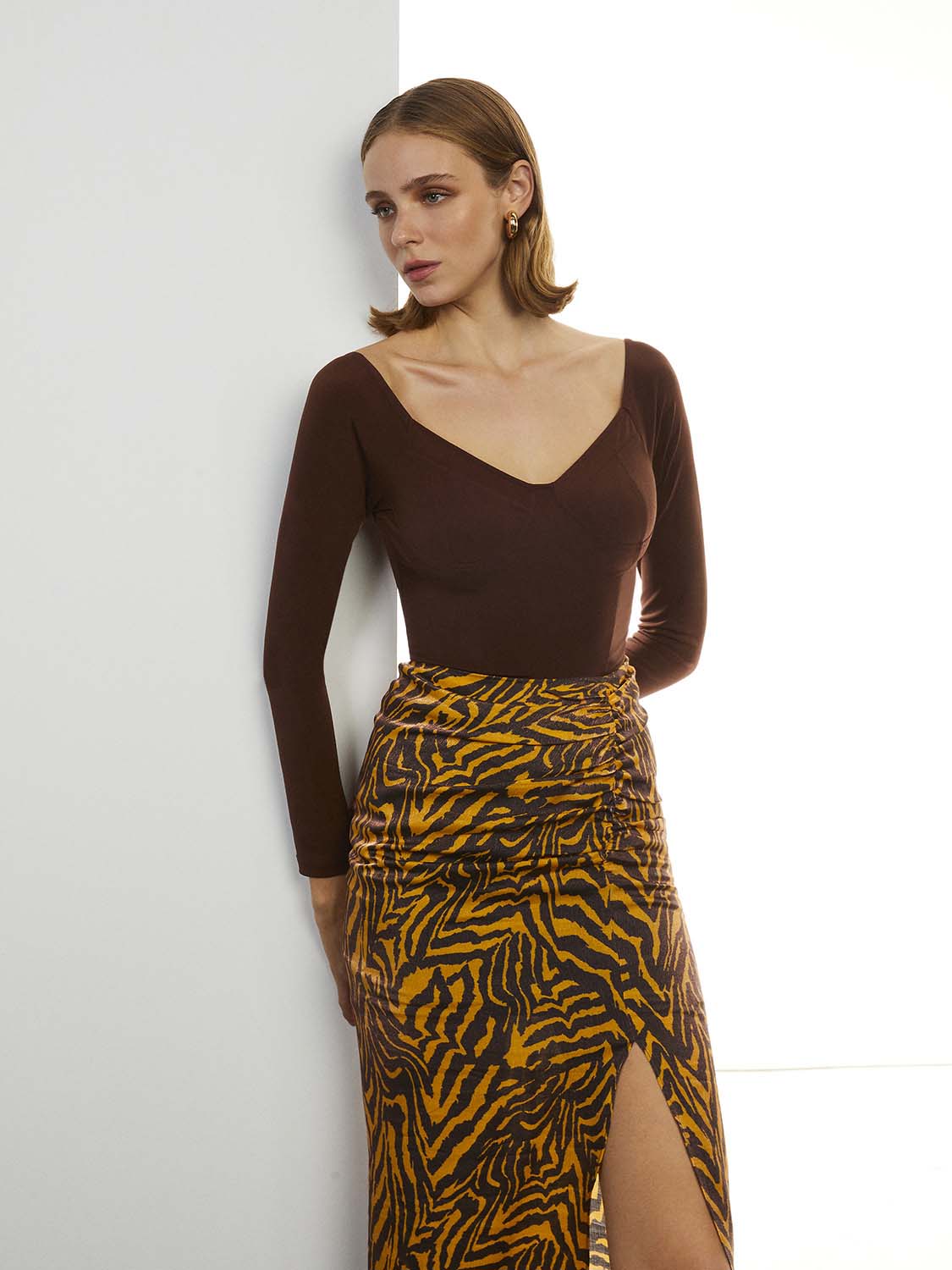 Scoop Neck Bodysuit in Neo Brown with long sleeves and open back design, showcasing its stylish and elegant look.