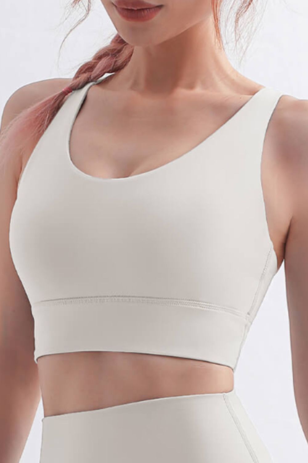 Scoop Neck Crisscross Back Sports Bra in solid color, showcasing its stylish design and comfortable fit, perfect for yoga and workouts.