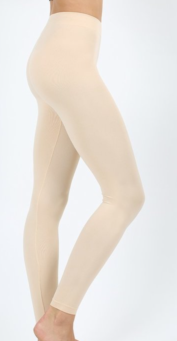 A pair of Seamless Classic Leggings in Eggshell and Cream, showcasing their soft and stretchy fabric.