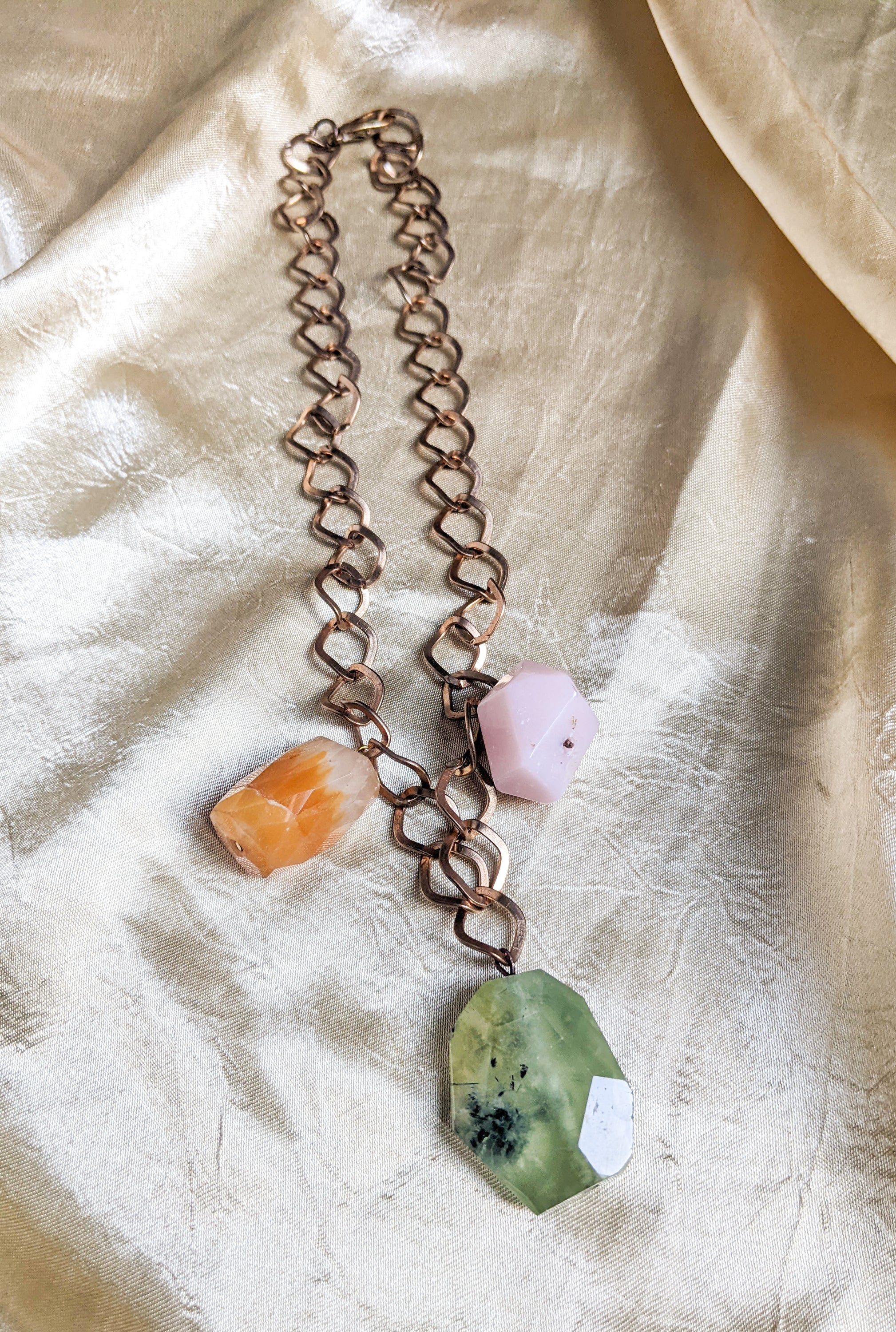 A beautiful semi-precious stones necklace featuring a luxurious golden chain, showcasing vibrant stones in various colors.