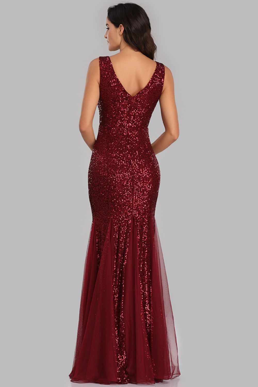 A glamorous Sequin Sleeveless Plunge Spliced Mesh Fishtail Dress featuring a V-neckline and a dramatic fishtail hem, perfect for evening events.