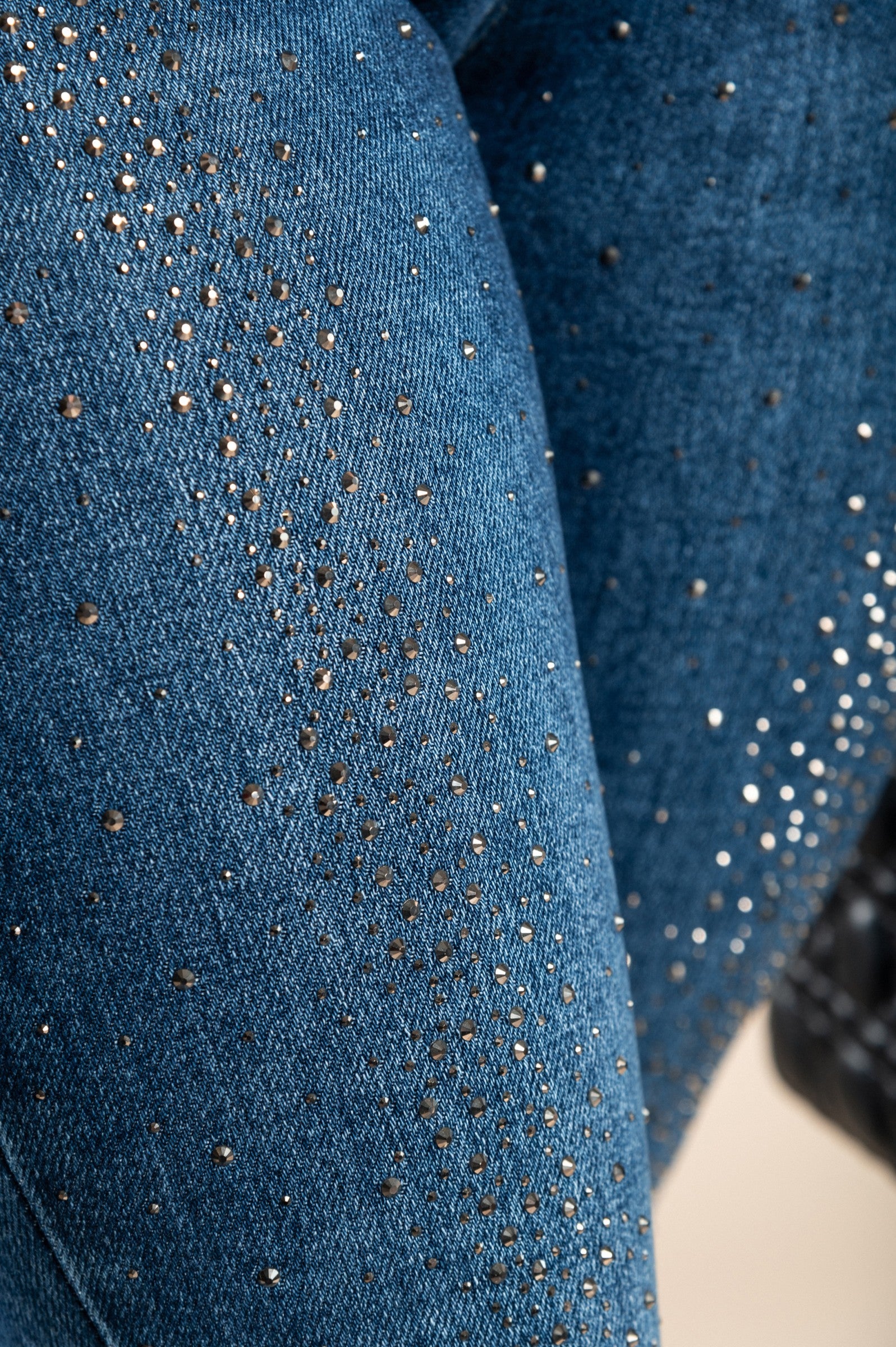 Stylish blue sequined skinny jeans with front and back pockets, featuring a button and zipper closure.