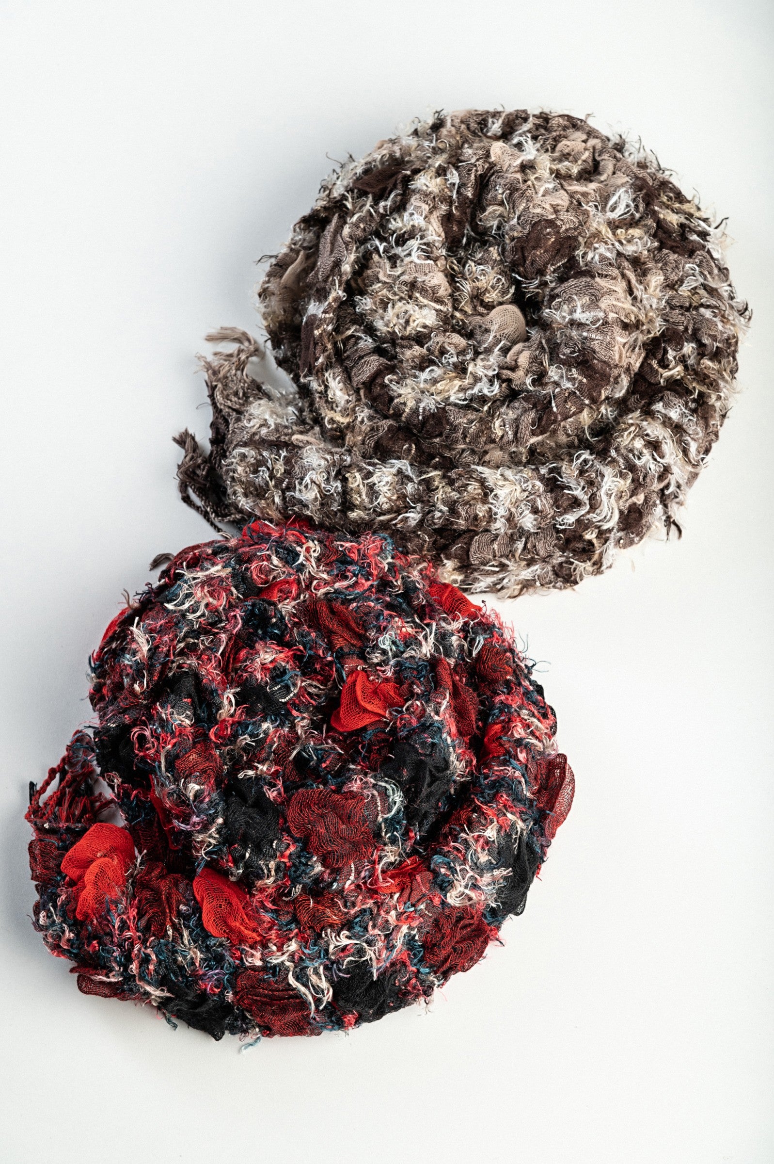 Set of 2 multicolored scarves in black, red, and brown, made from 100% viscose, showcasing their elegant design and soft texture.