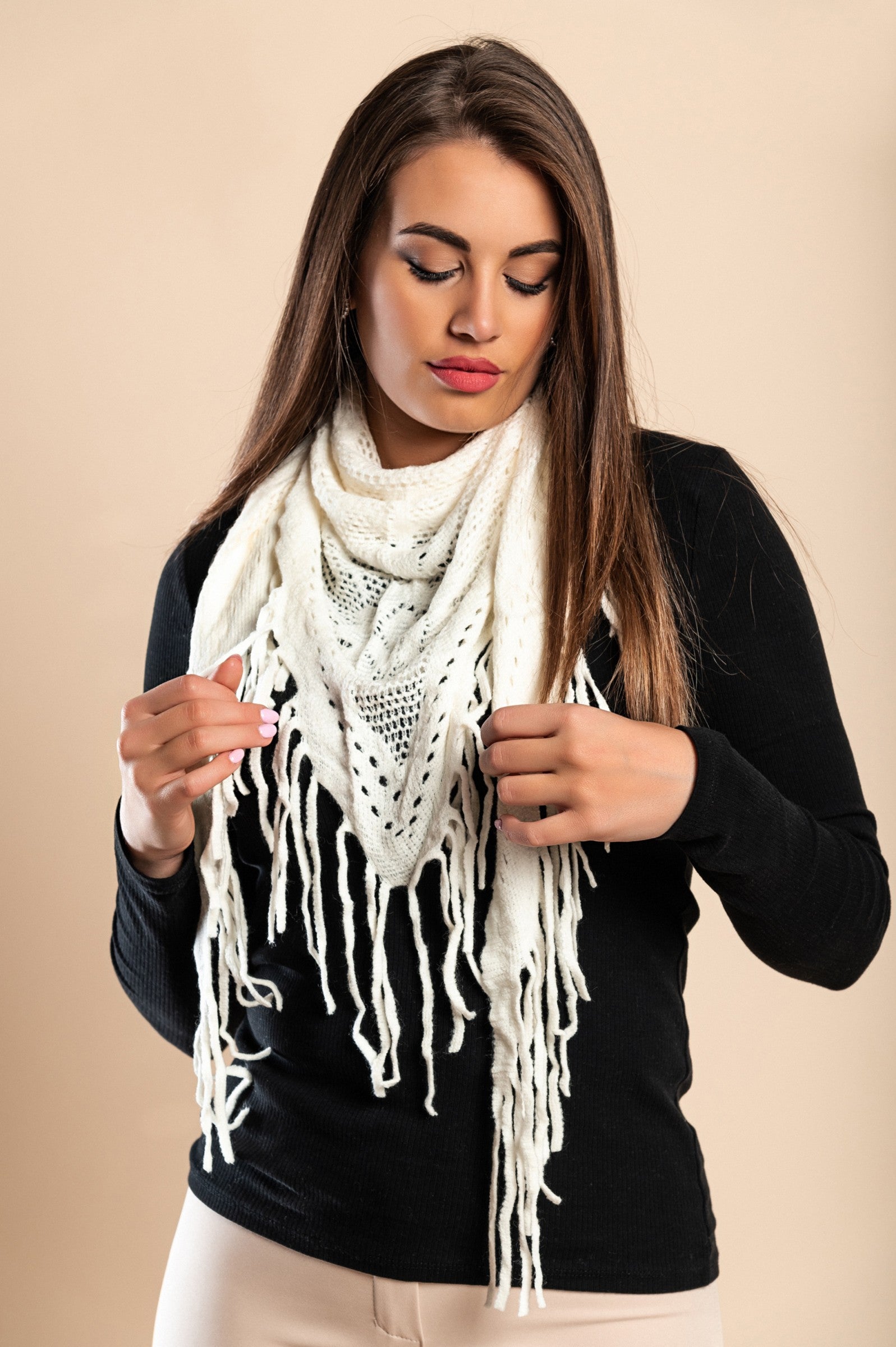 Set of 3 knitted scarves in white, black, and beige with fringes, showcasing their triangular shape and soft texture.