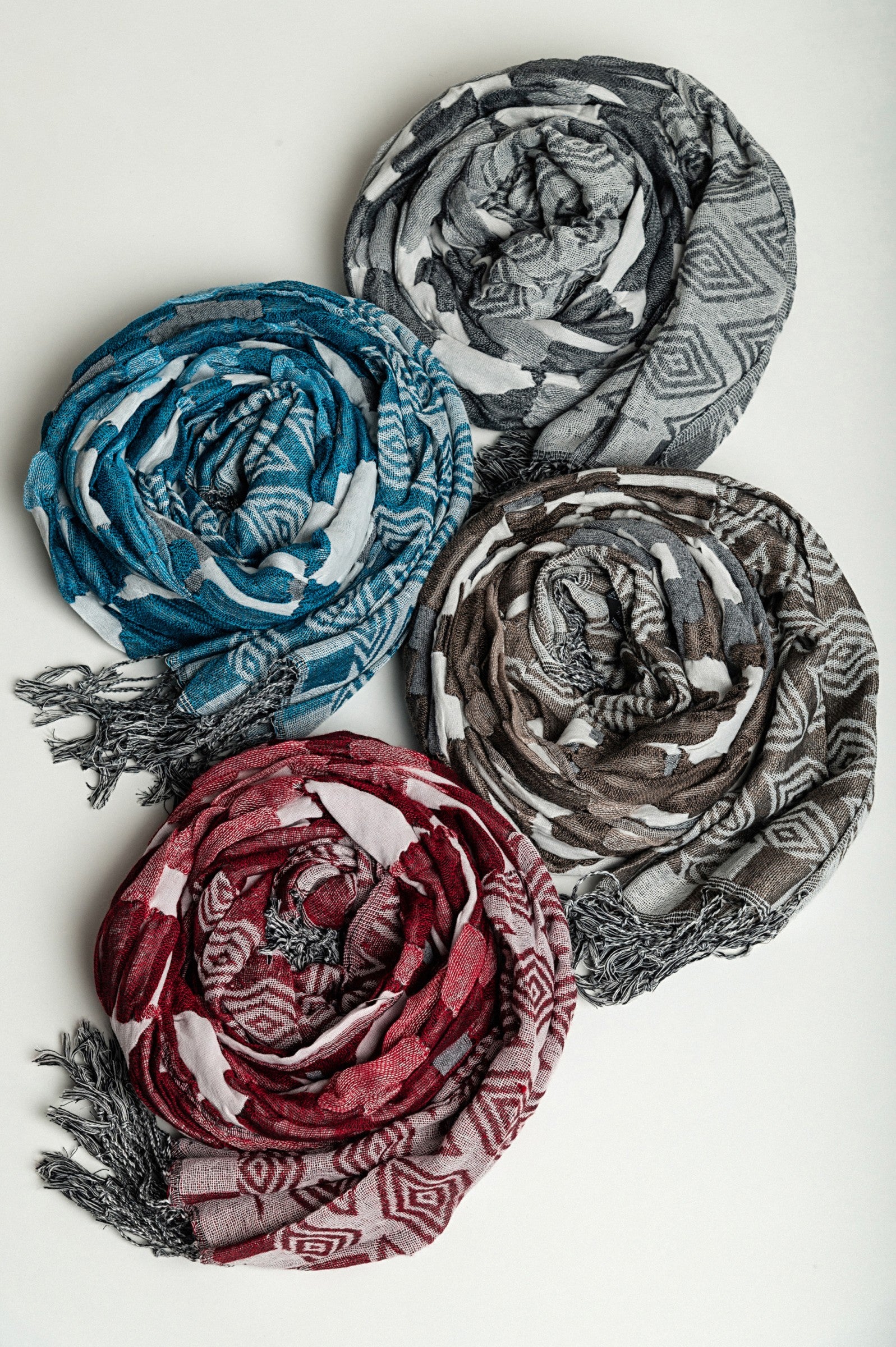 Set of 4 multicolored scarves in grey, burgundy, turquoise, and beige, made from 100% viscose, elegantly displayed.