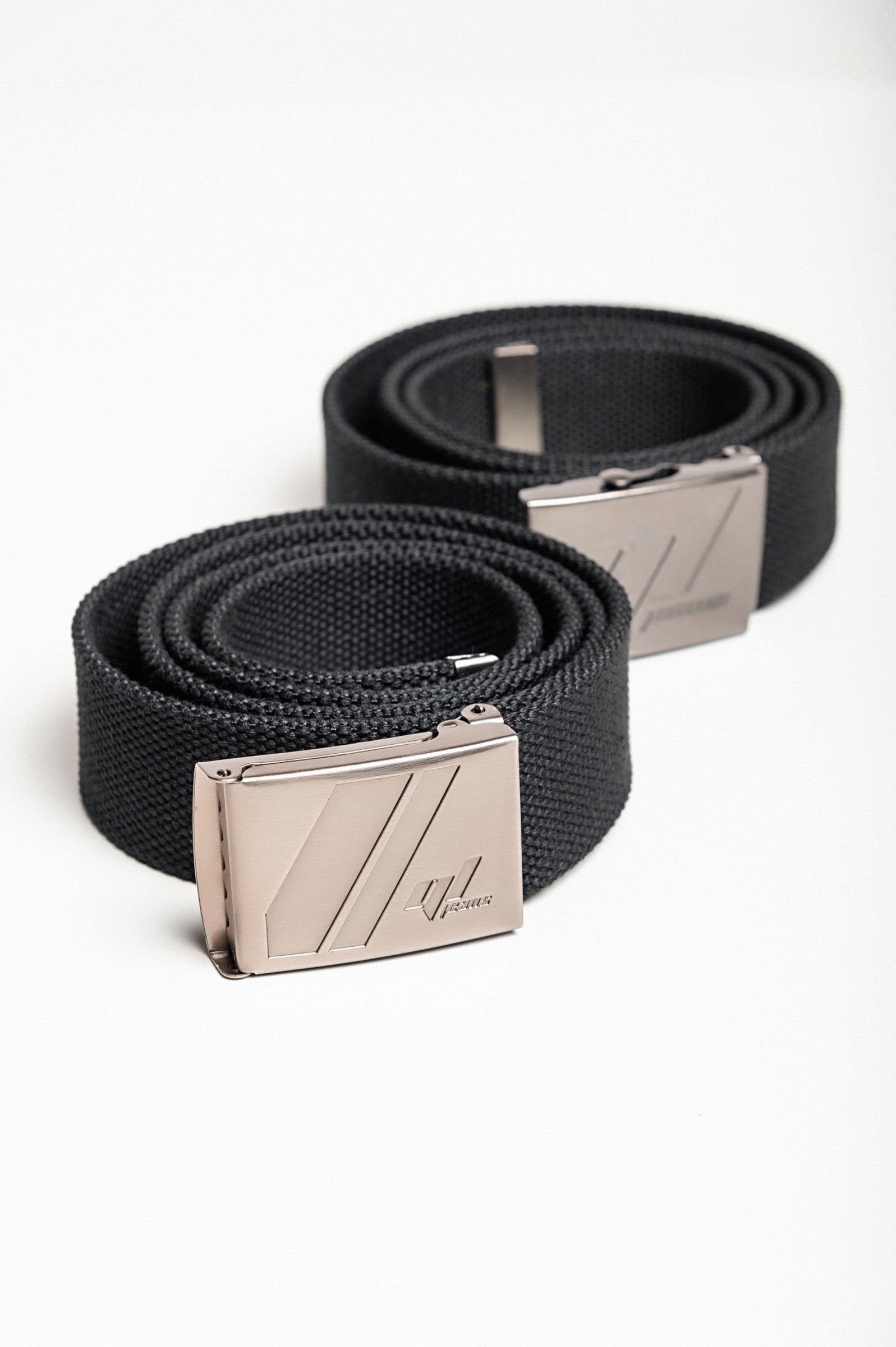 Set of two black trouser belts featuring durable metal buckles, adjustable lengths, and robust polyester material.