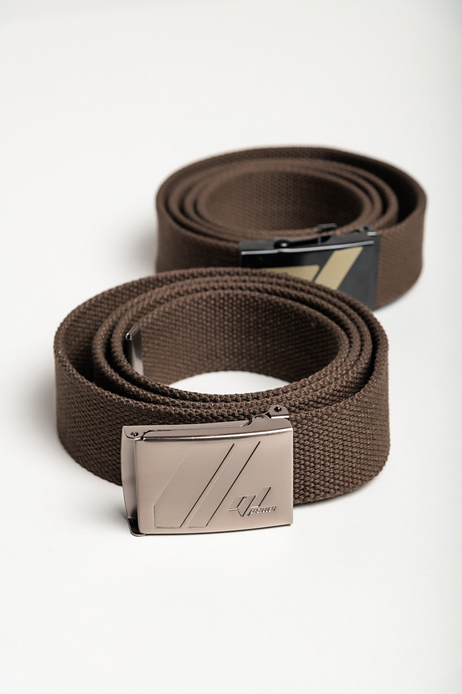 Set of two brown trouser belts featuring metal buckles, showcasing their adjustable length and durable material.