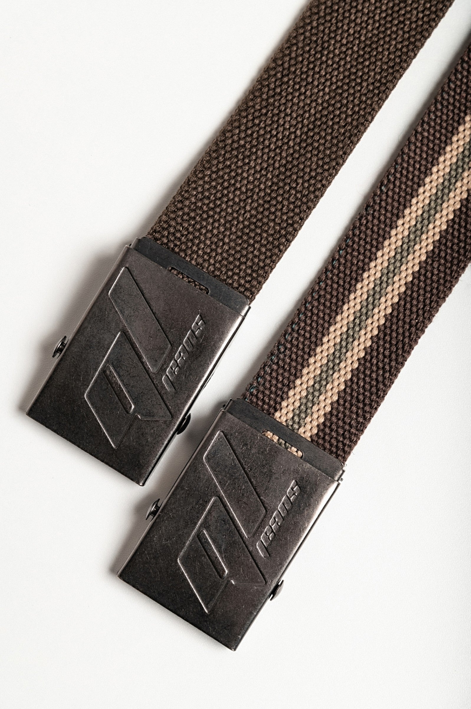 Set of two multicolored belts featuring a brown and striped brown design with a metal buckle.