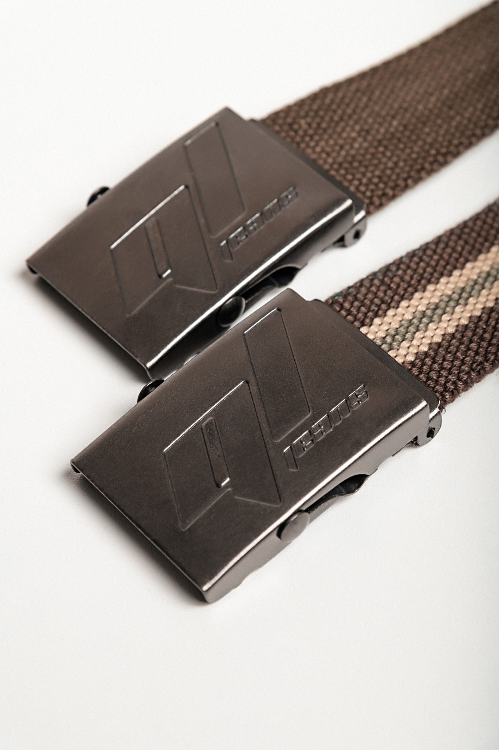 Set of two multicolored belts with metal buckle, featuring a classic brown and striped brown design.