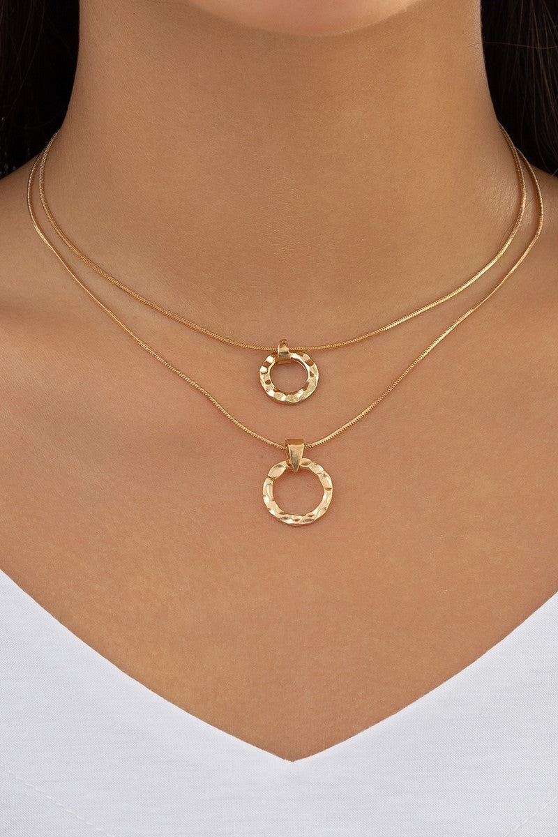 Set of two elegant gold necklaces featuring round pendants, showcasing their stylish design and metal lobster clasp.