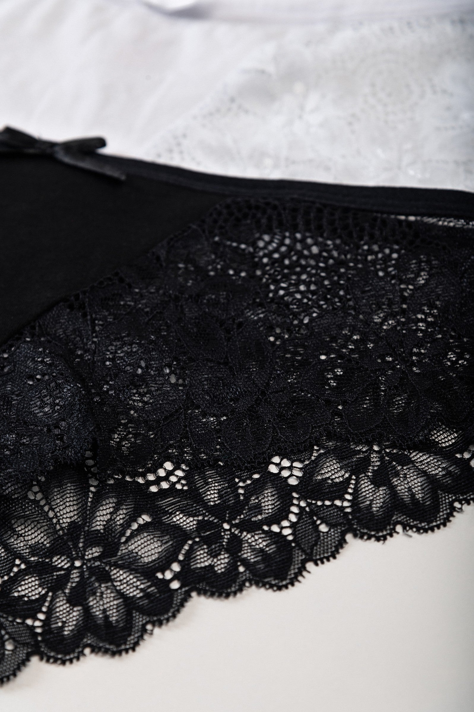 Set of two lace panties in black and white, showcasing elegant design and high-quality fabric.