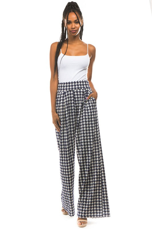 A pair of sexy multi-print palazzo pants featuring an elasticized waist and side pockets, perfect for stylish comfort.