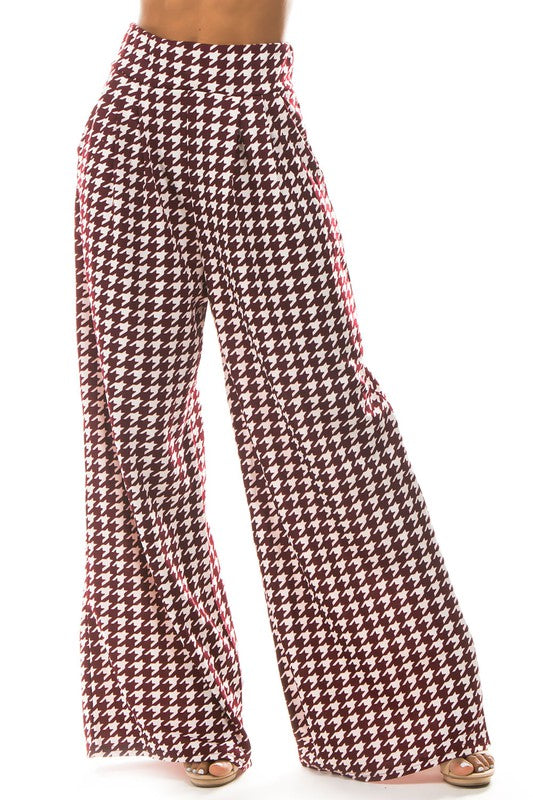 A pair of sexy multi-print palazzo pants featuring an elasticized waist and side pockets, perfect for stylish and comfortable wear.