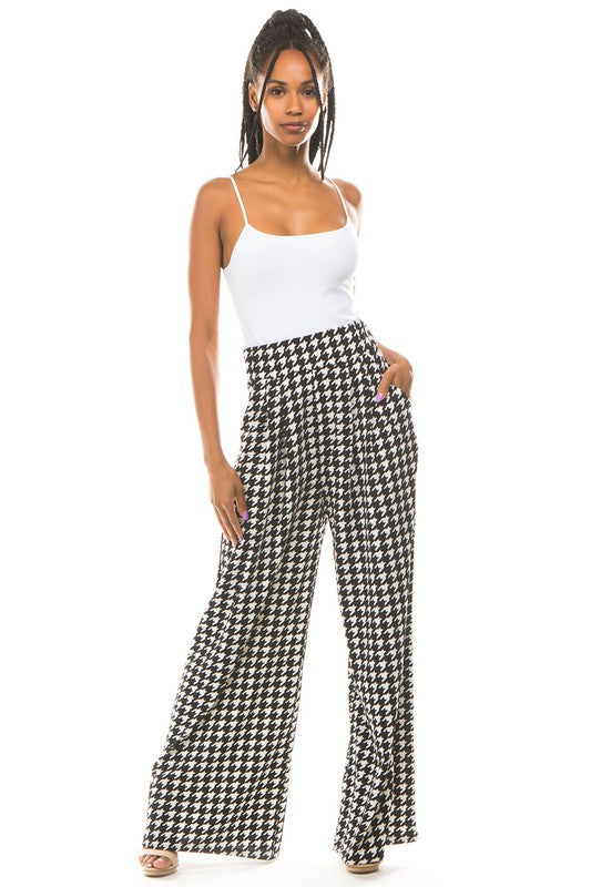 A pair of sexy multi-print palazzo pants featuring an elasticized waist and side pockets, perfect for stylish comfort.