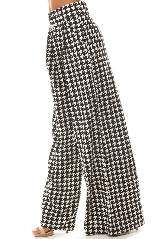 A pair of sexy multi-print palazzo pants featuring an elasticized waist and side pockets, perfect for stylish comfort.