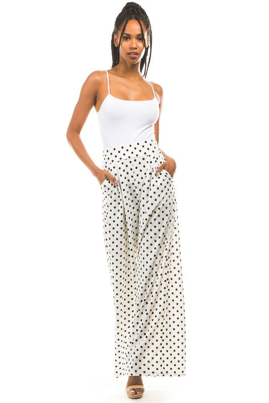 A pair of sexy multi-print palazzo pants with an elasticized waist and side pockets, displayed on a model.