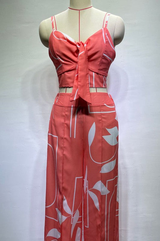 A stylish model wearing a sexy summer two-piece pant set featuring a sleeveless crop top and elasticized waist pants.