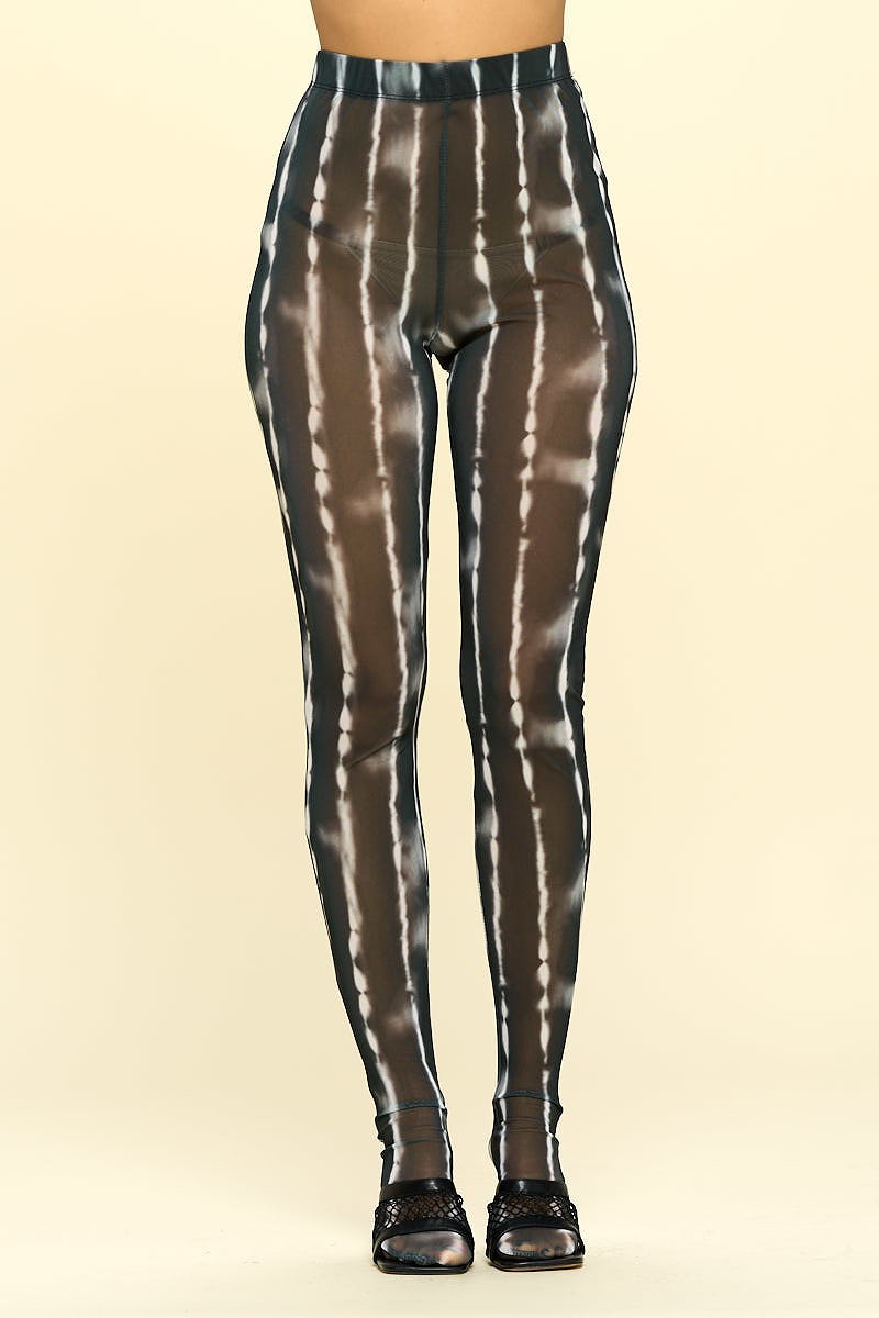 A pair of sheer high rise leggings in black and ivory, showcasing their stylish design and elastic waistband.