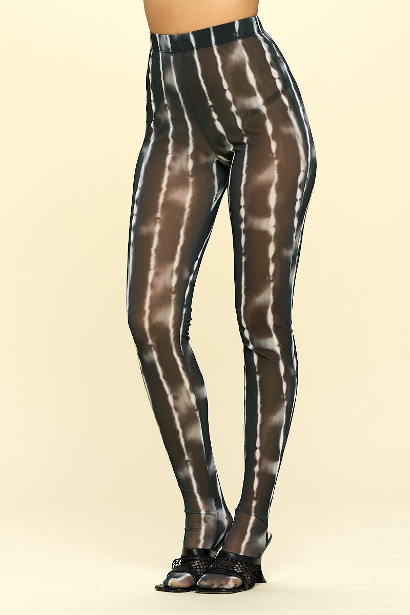 A pair of sheer high rise leggings in black and ivory, showcasing their stylish design and elastic waistband.