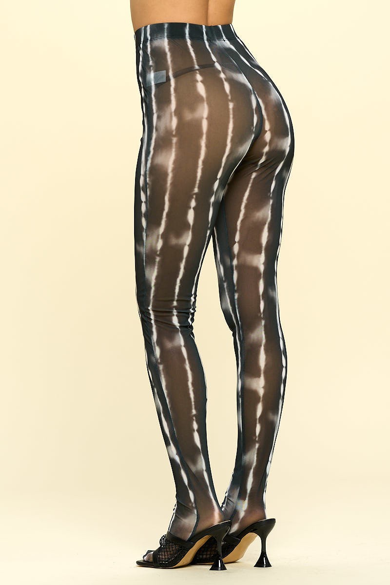 A pair of sheer high rise leggings in black and ivory, showcasing their stylish design and elastic waistband.