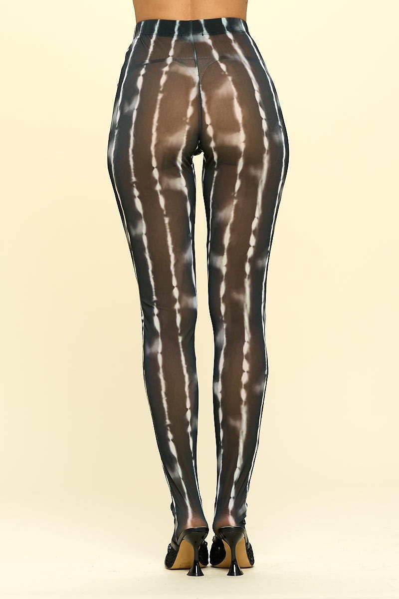 A pair of sheer high rise leggings in black and ivory, showcasing their stylish design and elastic waistband.