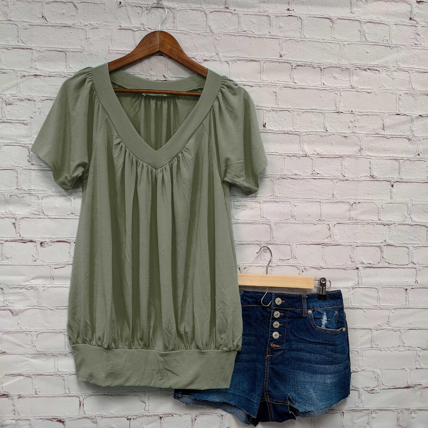 A stylish Shirred V-neck Short Sleeve Top featuring a pleated design and fitted elastic waistband, available in various colors.