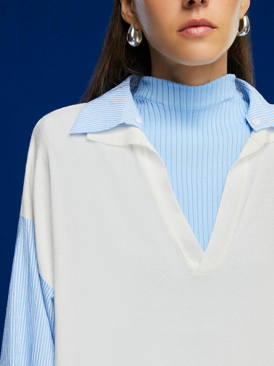 A stylish Shirt Collar Knit Top featuring a drop shoulder design, plaid details at the collar and sleeves, and elastic cuffs for a comfortable fit.