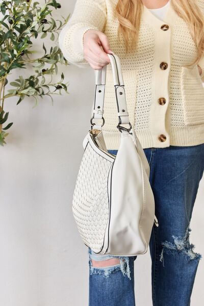 SHOMICO Weaved Vegan Leather Handbag showcasing intricate weaving and a stylish crossbody strap.