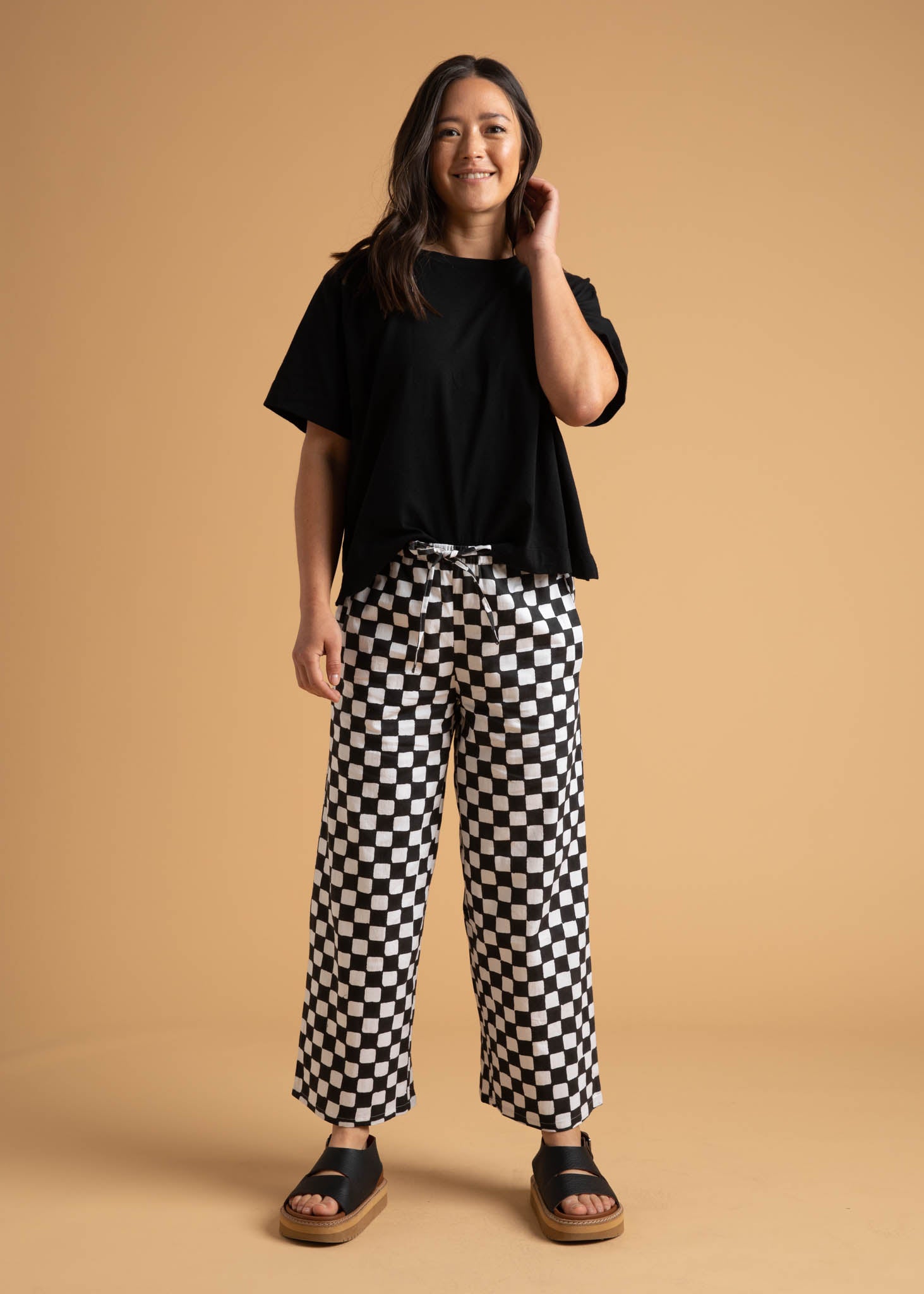 Shore Pant in Checkerboard Black featuring a modern cropped length and relaxed fit, made from sustainable organic cotton.