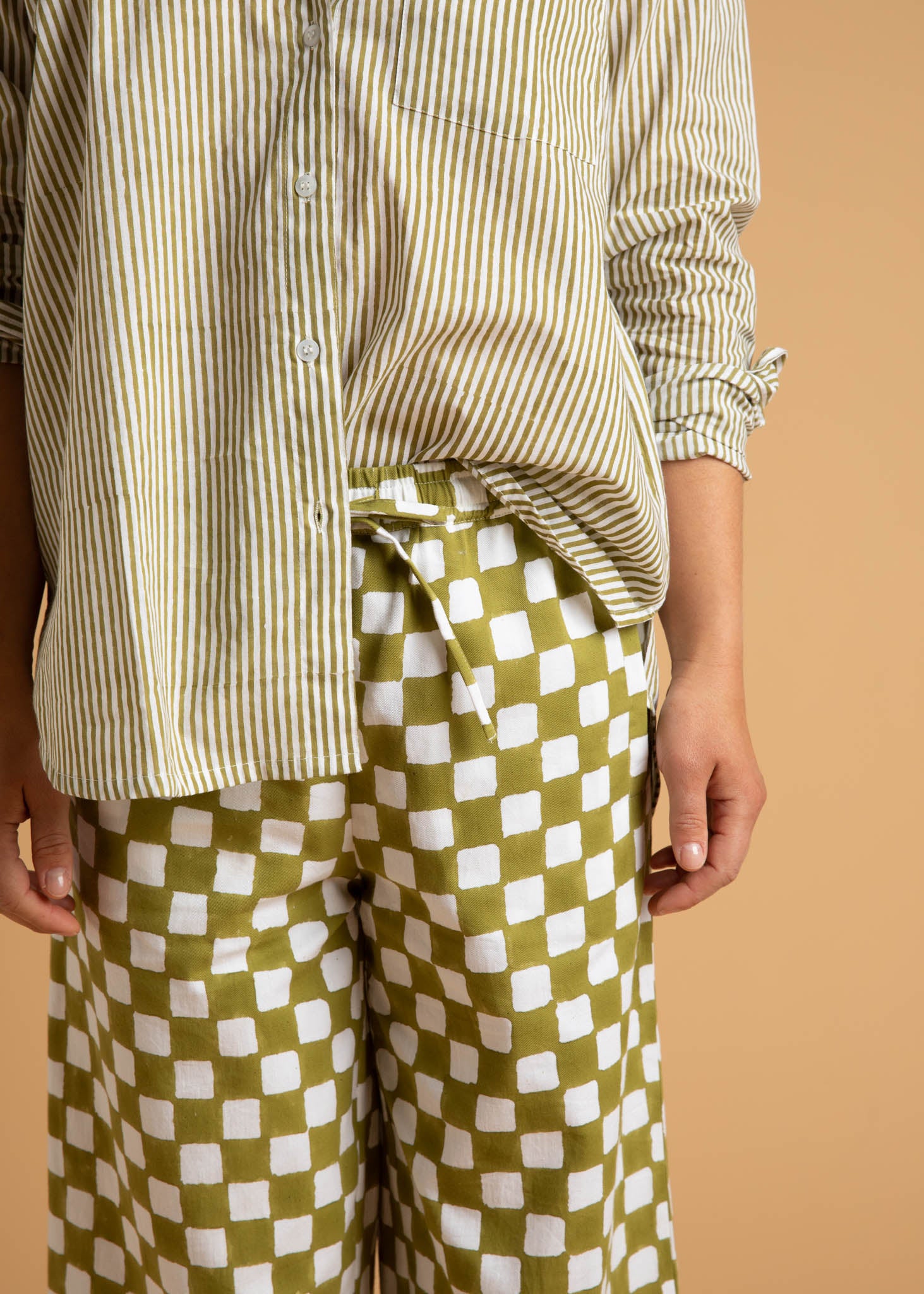 Shore Pant in Checkerboard Olive Oil, showcasing a modern cropped design with a relaxed fit and elastic waist, made from organic cotton.