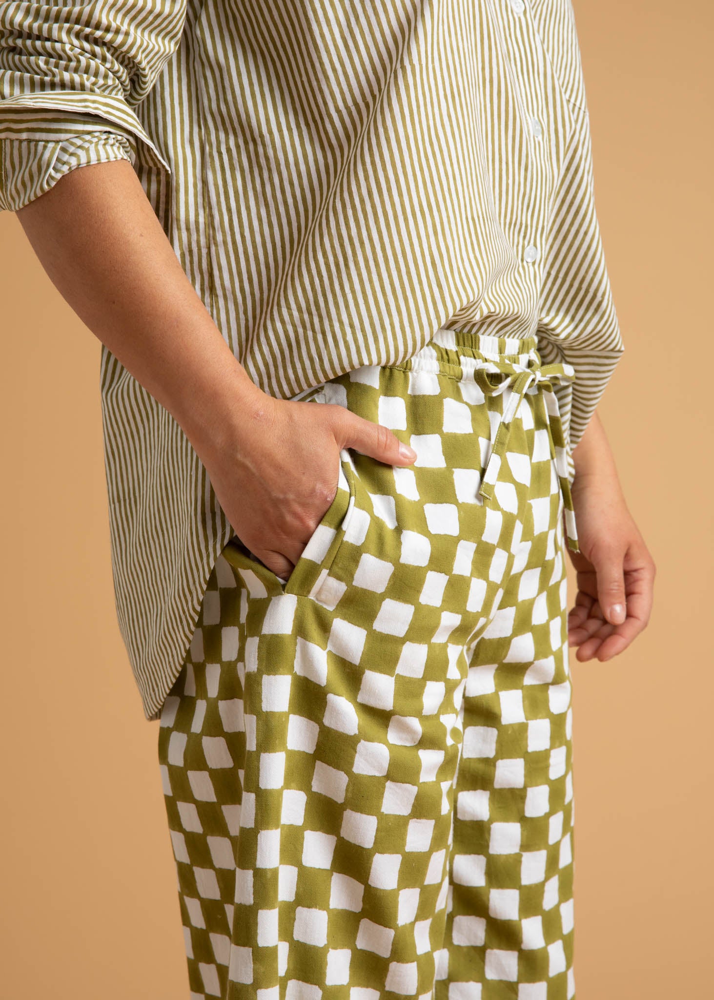 Shore Pant in Checkerboard Olive Oil, showcasing a modern cropped design with a relaxed fit and elastic waist, made from organic cotton.