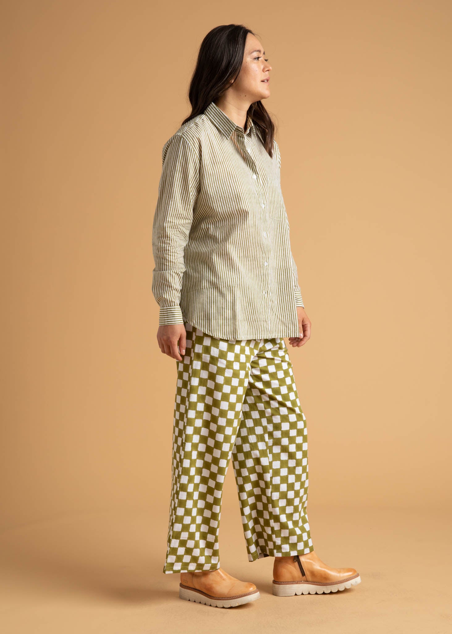 Shore Pant in Checkerboard Olive Oil, showcasing a modern cropped design with a relaxed fit and elastic waist, made from organic cotton.