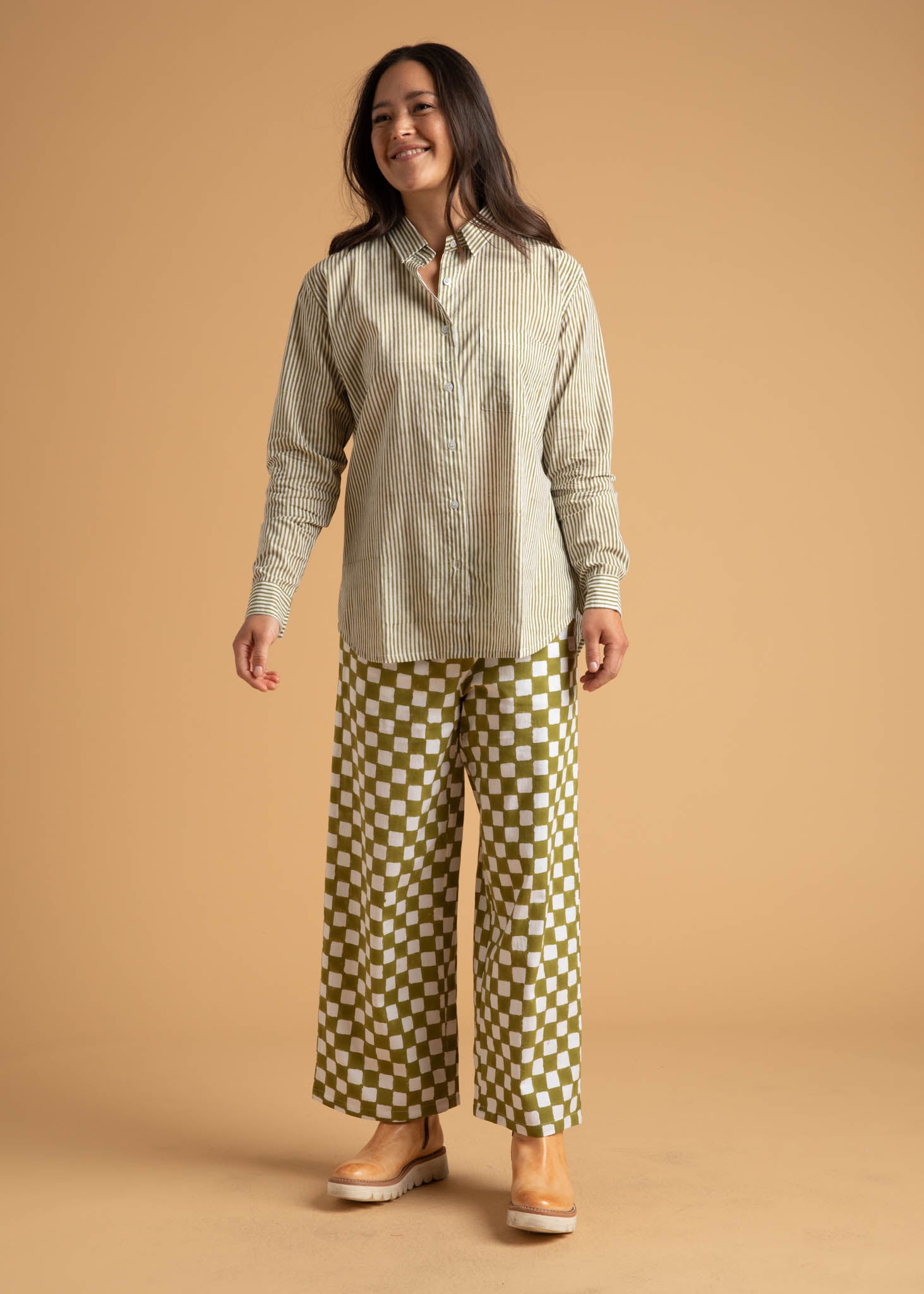 Shore Pant in Checkerboard Olive Oil, showcasing a modern cropped design with a relaxed fit and elastic waist, made from organic cotton.