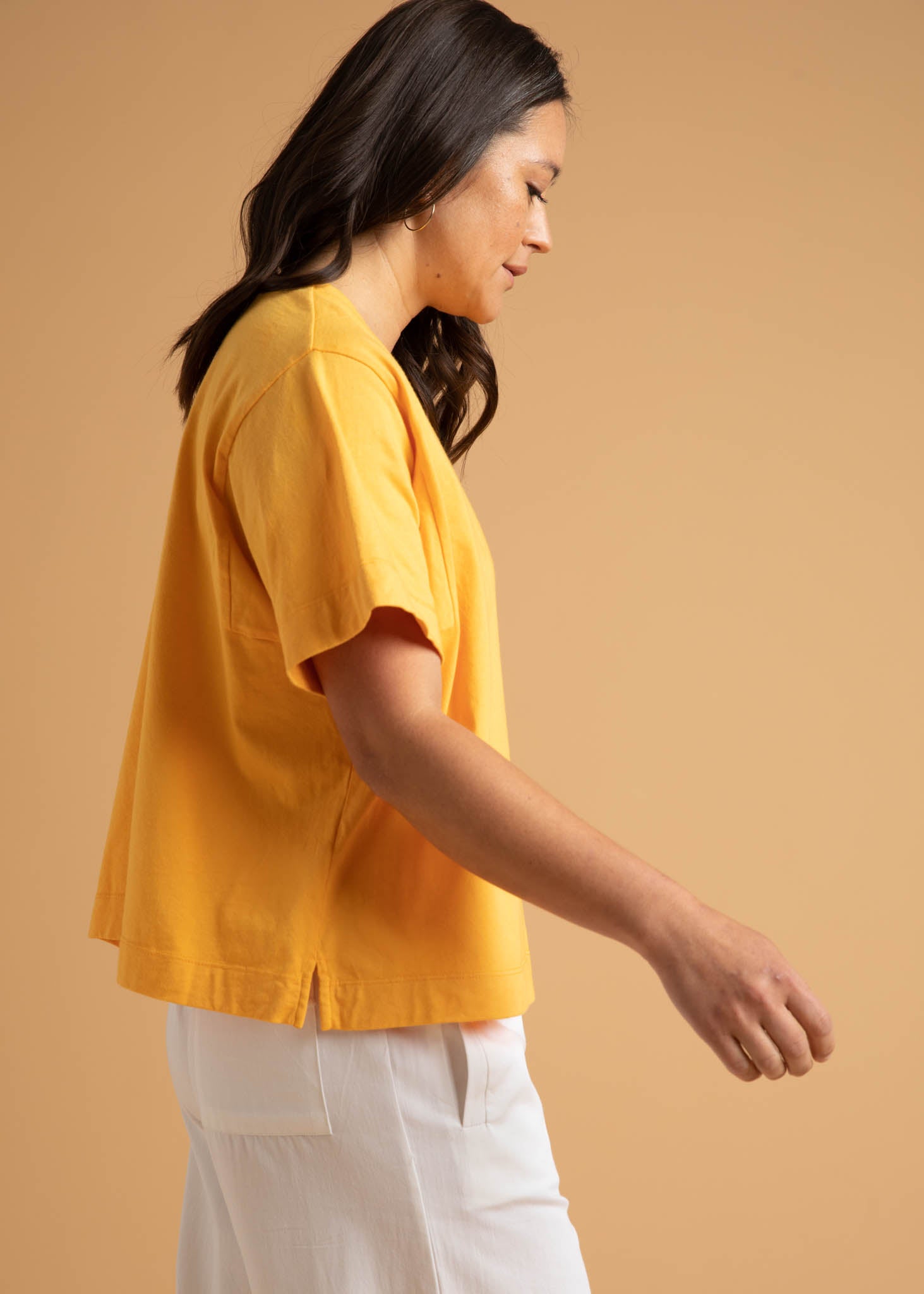 A pair of Shore Pants in Natural color, featuring a modern cropped length, relaxed fit, and elastic waist, displayed on a neutral background.