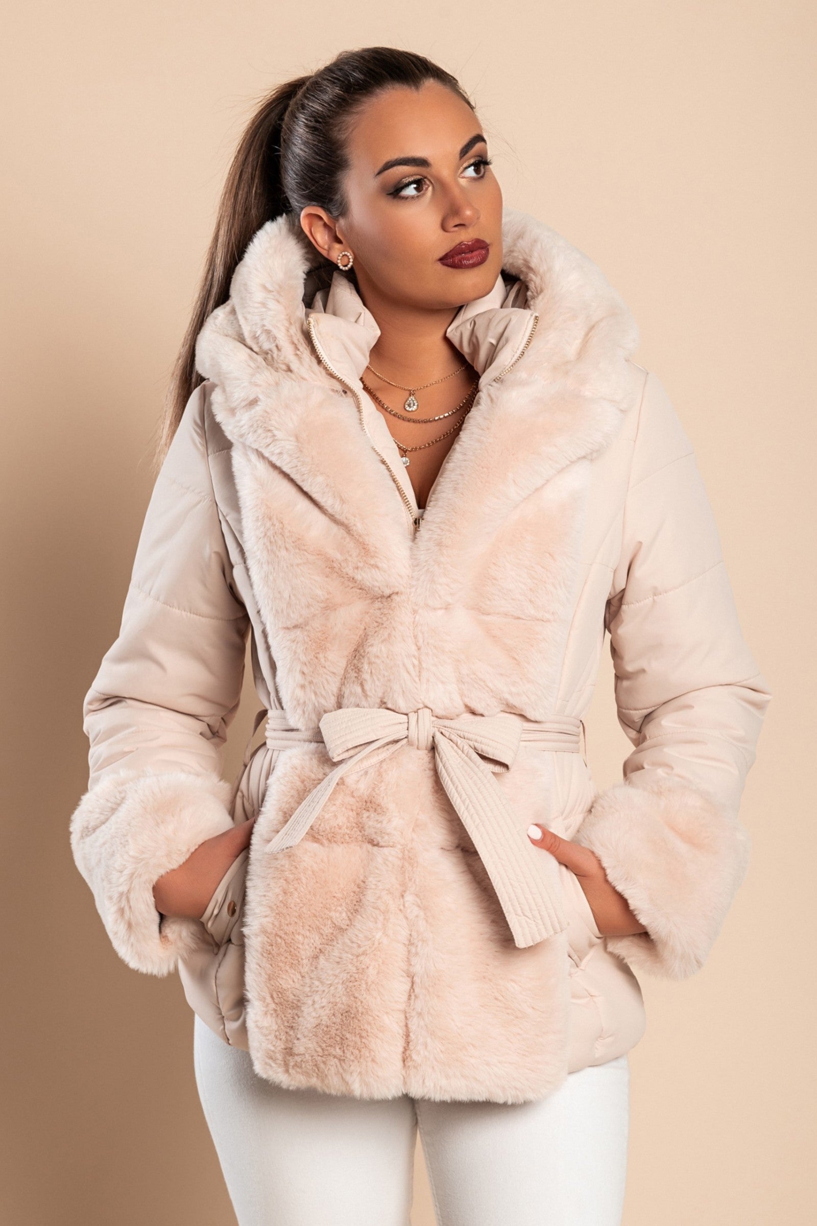 Beige short padded jacket with removable faux fur trim, featuring side pockets and a metal zipper closure.