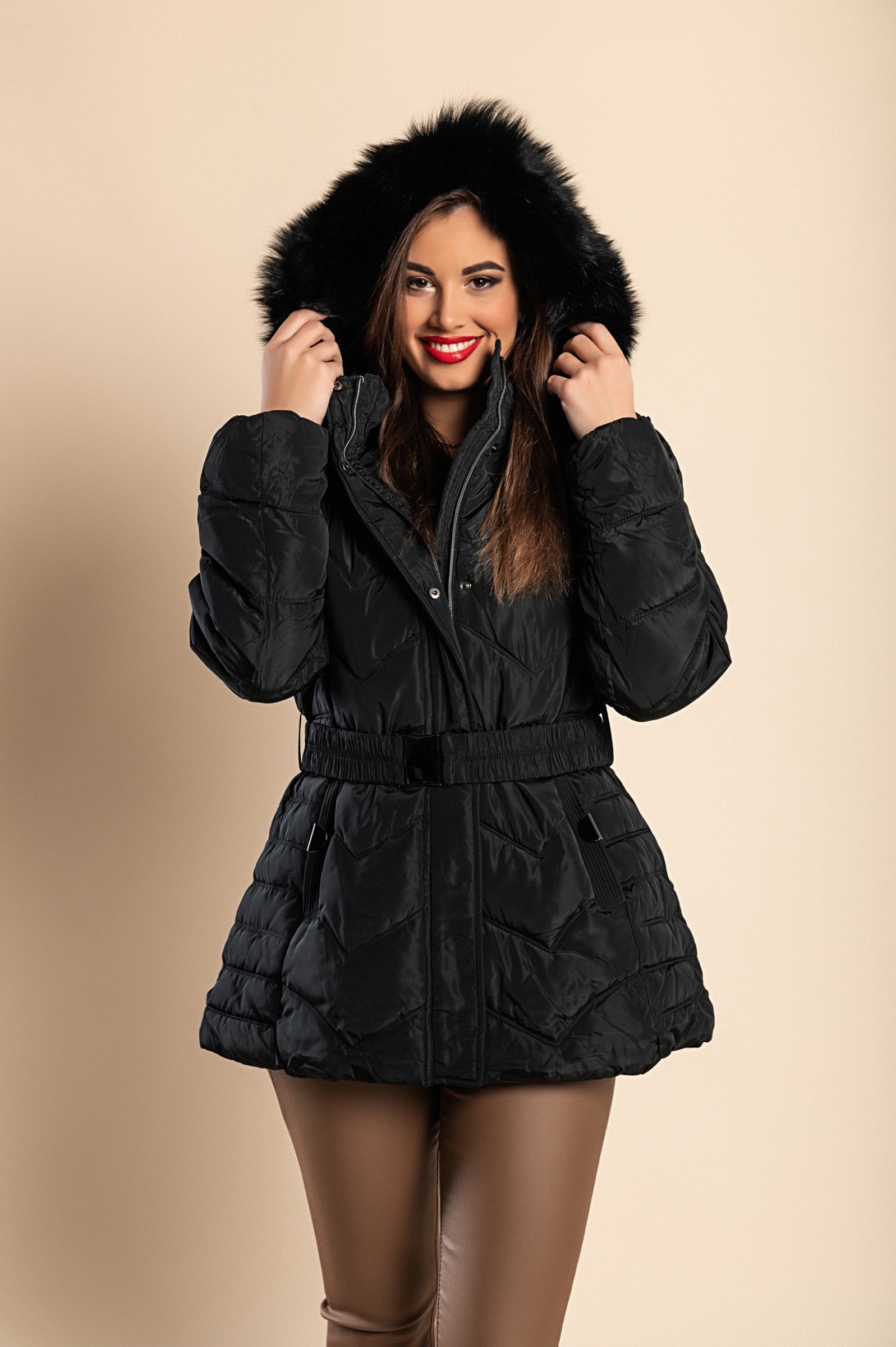 A stylish plus size black padded jacket with a hood and synthetic fur, featuring a high collar, zip closure, and side pockets.