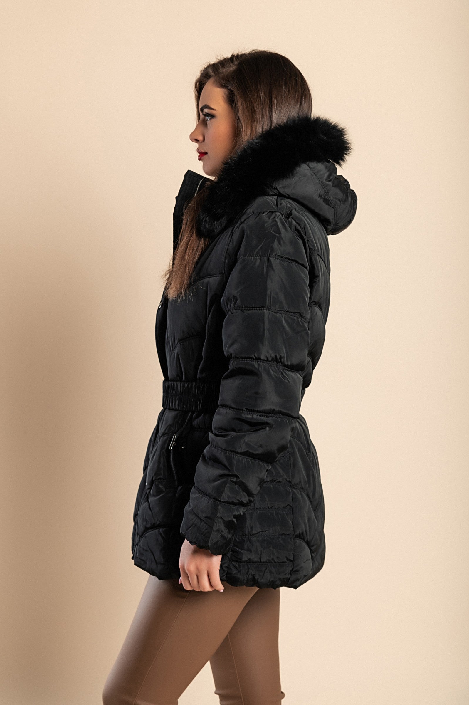 A stylish plus size black padded jacket with a hood and synthetic fur, featuring a high collar, zip closure, and side pockets.