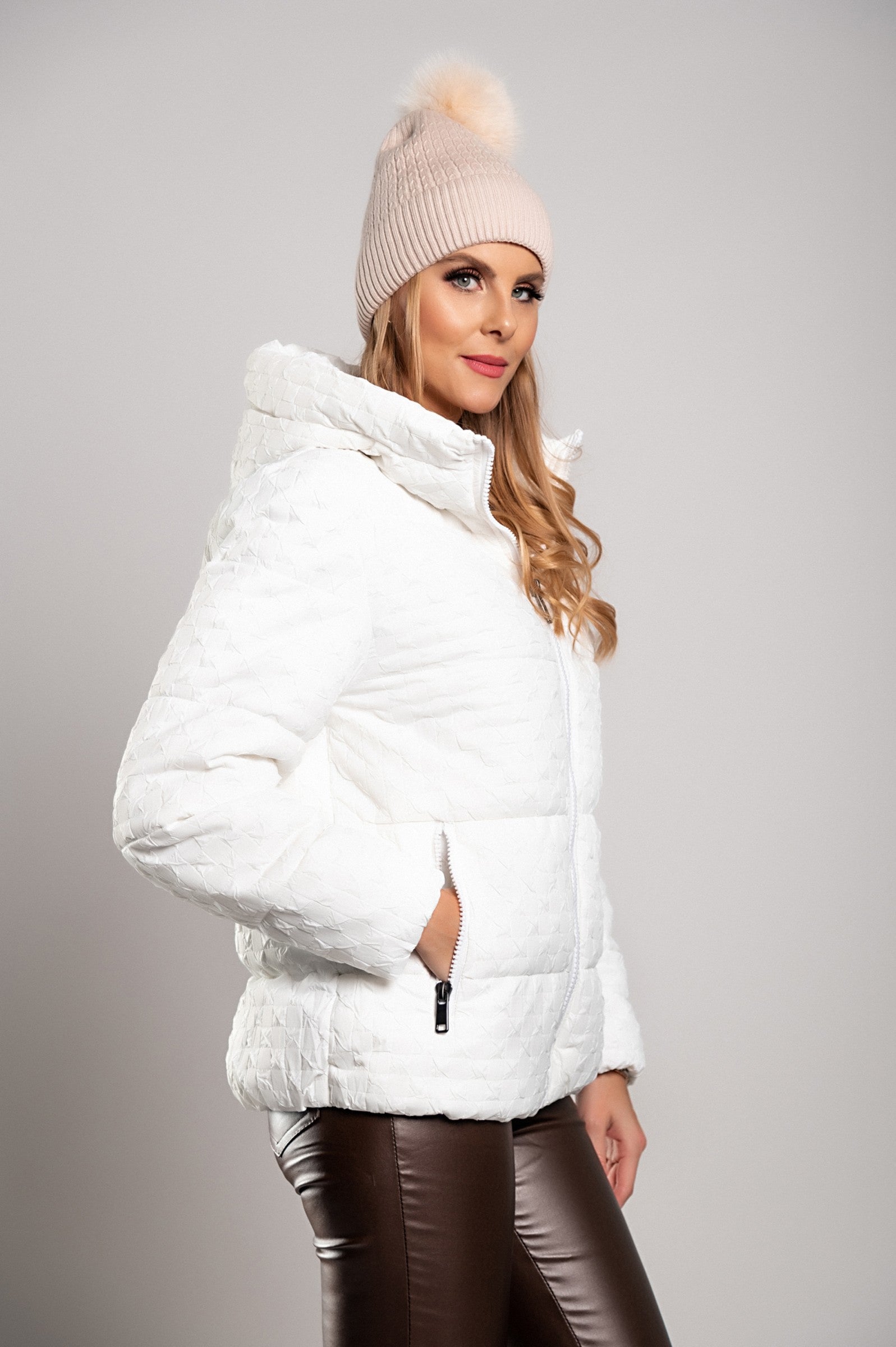 White short padded jacket with hood, featuring a high collar and zipped side pockets, perfect for winter wear.